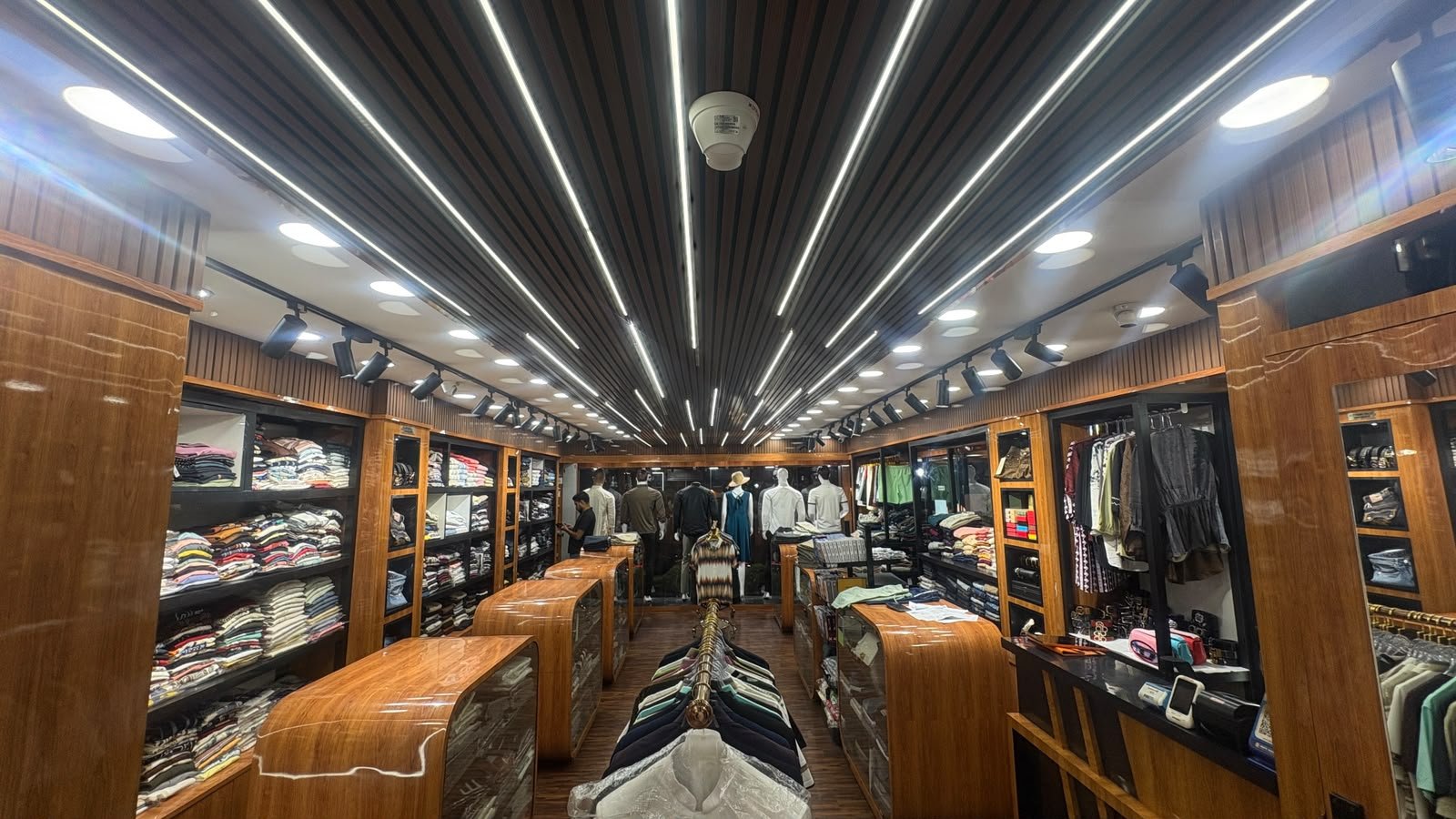 Denim and casualwear displayed on shelving with a full view of the showroom aisle