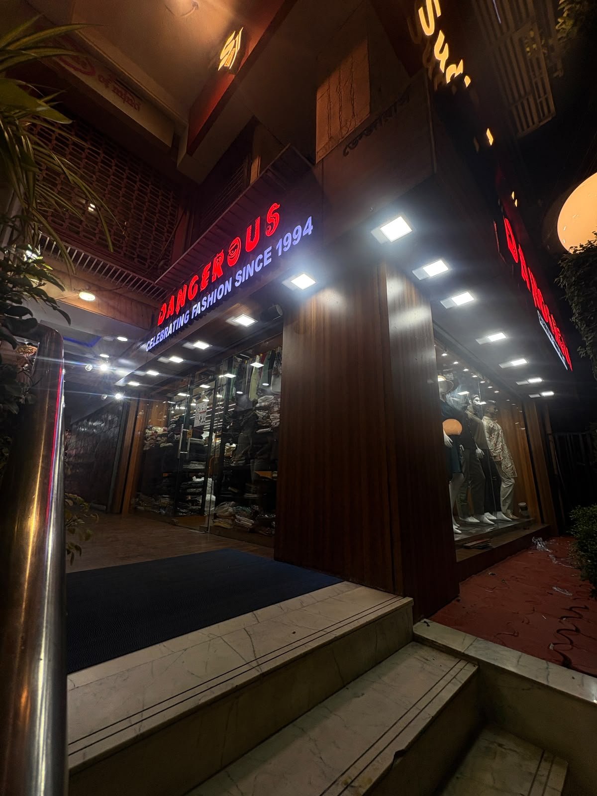 Dangerous Fashion storefront lit up at night on Lee Road, Kolkata